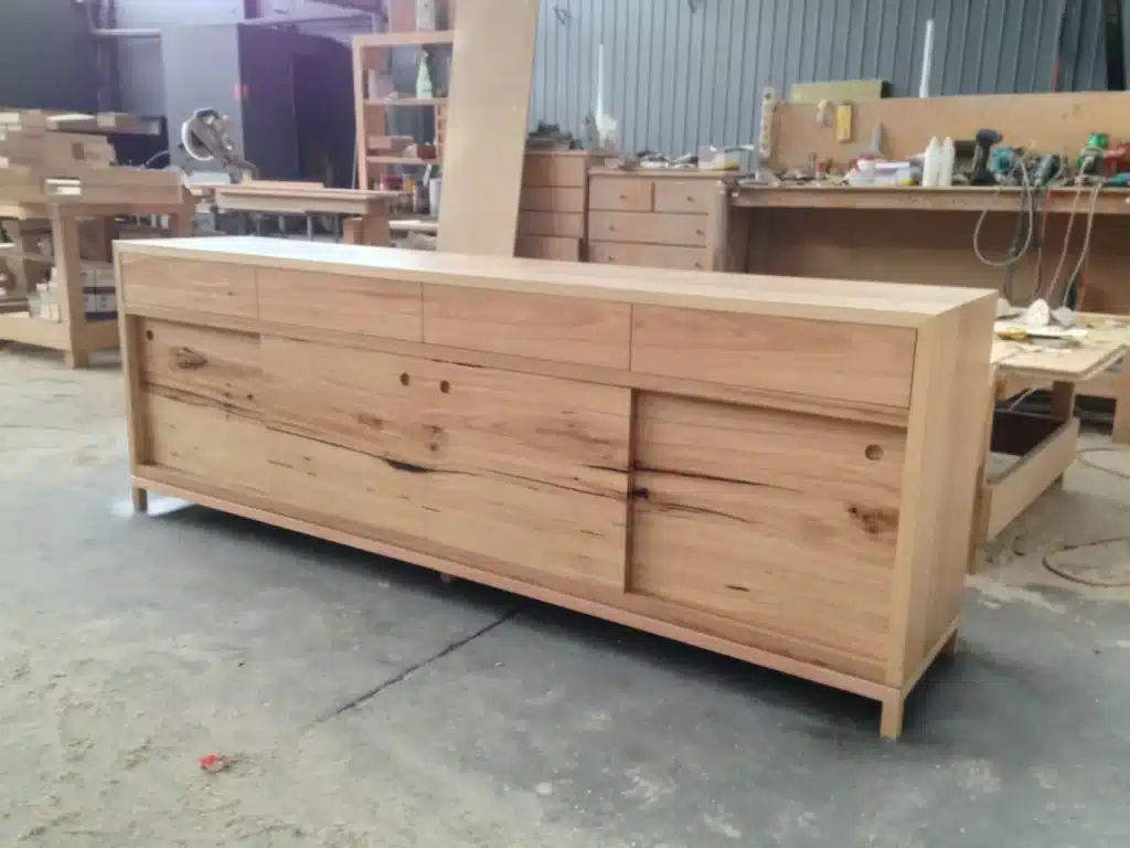 Long custom timber sideboard with slim legs and natural grain